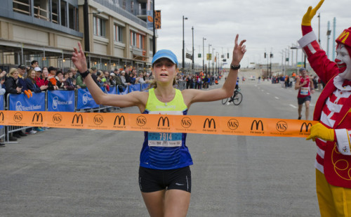 Women’s winner Tina Muir of Lexington, KY prepares to cross the finish line on Second Street during 106th Thanksgiving Day Race and Walk Thursday November 26, 2015 in Downtown, Cincinnati. Photo by Joseph Fuqua II for WCPO